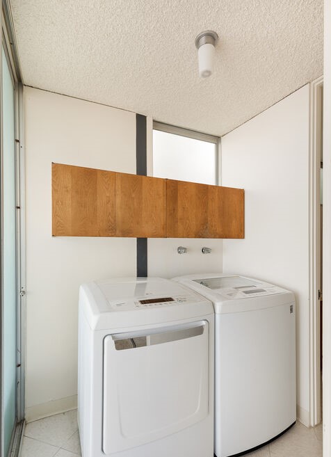 Clean lines and white walls in this architectural laundry room. 