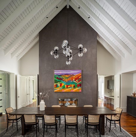 Dramatic formal dining room with soaring A-Frame white beamed ceiling