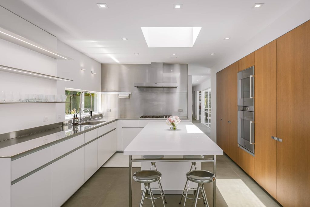 Clean lines and white walls in this architectural chef's kitchen with large center island