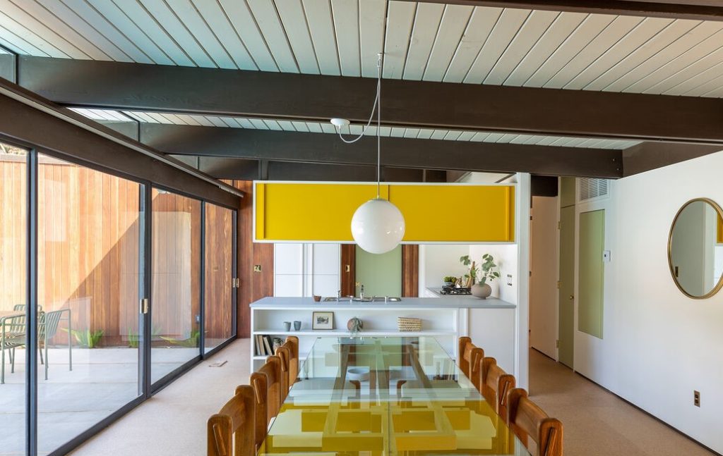 Horizontal massings of redwood siding and unpainted masonry block give privacy to a glass walled pavilion.