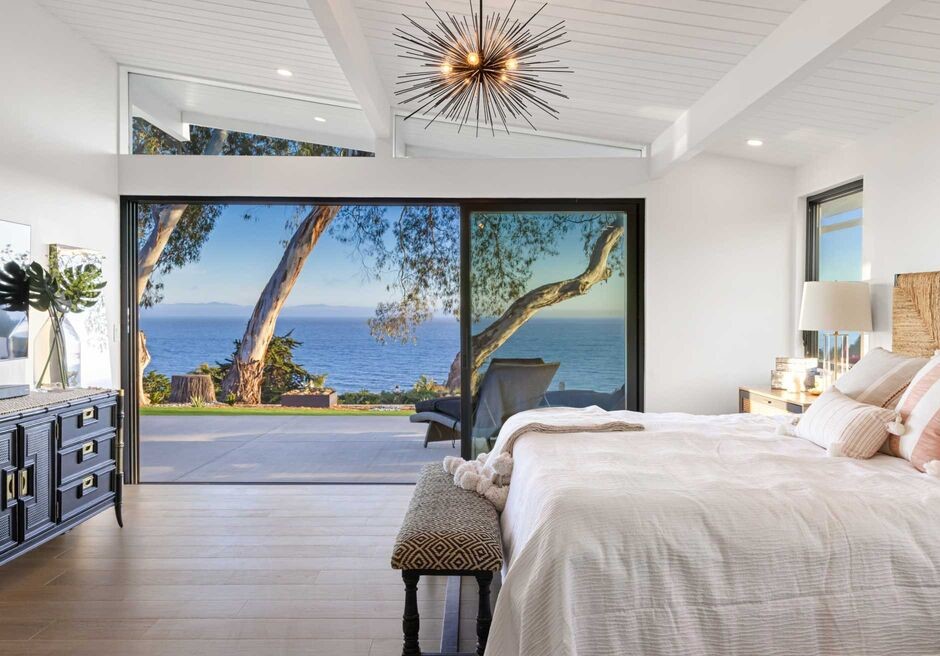 The primary suite enjoys ocean vistas and along with a zen spa bathroom with a freestanding tub,