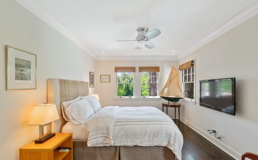 Upstairs are three large bedrooms and two bathrooms; the main bedroom has an updated bathroom