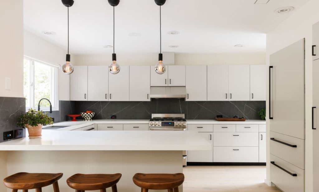 Dramatic chef's kitchen with clean white lines and classic modern features