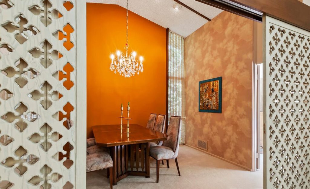 A burnt orange backdrop for the dining room really sets the mood.