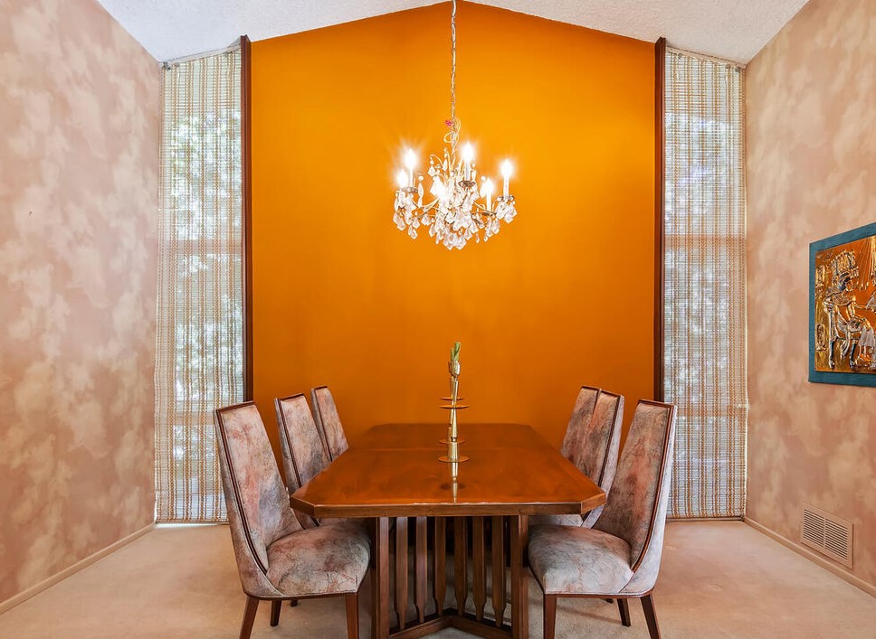 A burnt orange backdrop for the dining room really sets the mood.