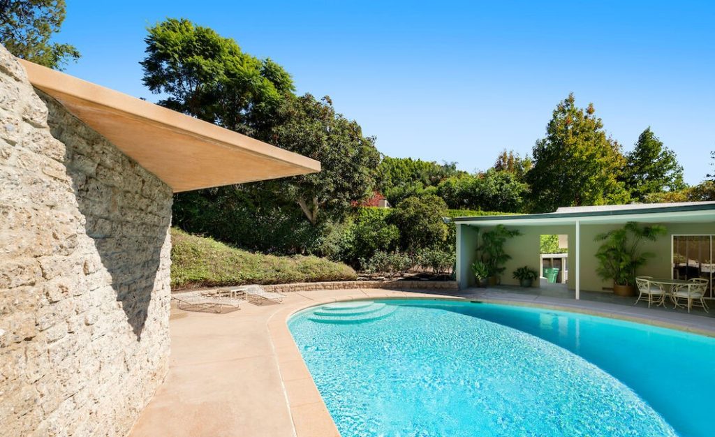 Beverly Hills Brilliant Mid Century Architectural presents an incredible round sparkling pool yard.