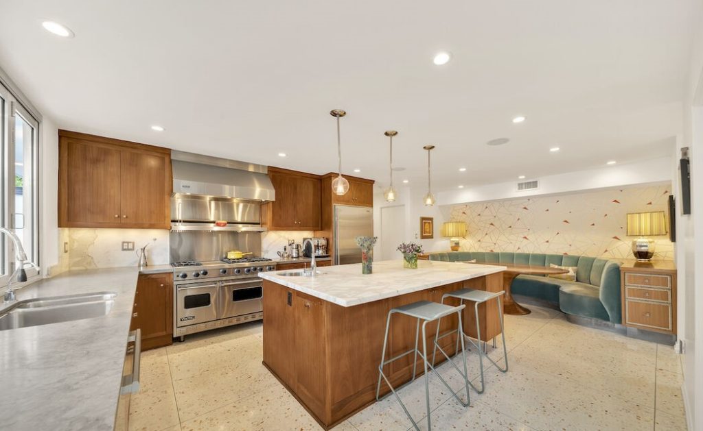 It has a true chef's kitchen with a huge center island, high end appliances and inviting built-in banquette.