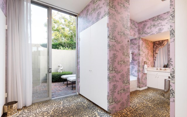 The original spa-like primary bathroom enjoys a dressing area & access to a private patio.
