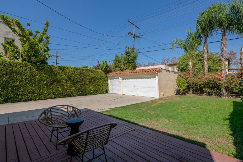 Out back boasts an ample sized yard and wooden deck area great for entertaining. A detached three car garage allows for plenty of storage