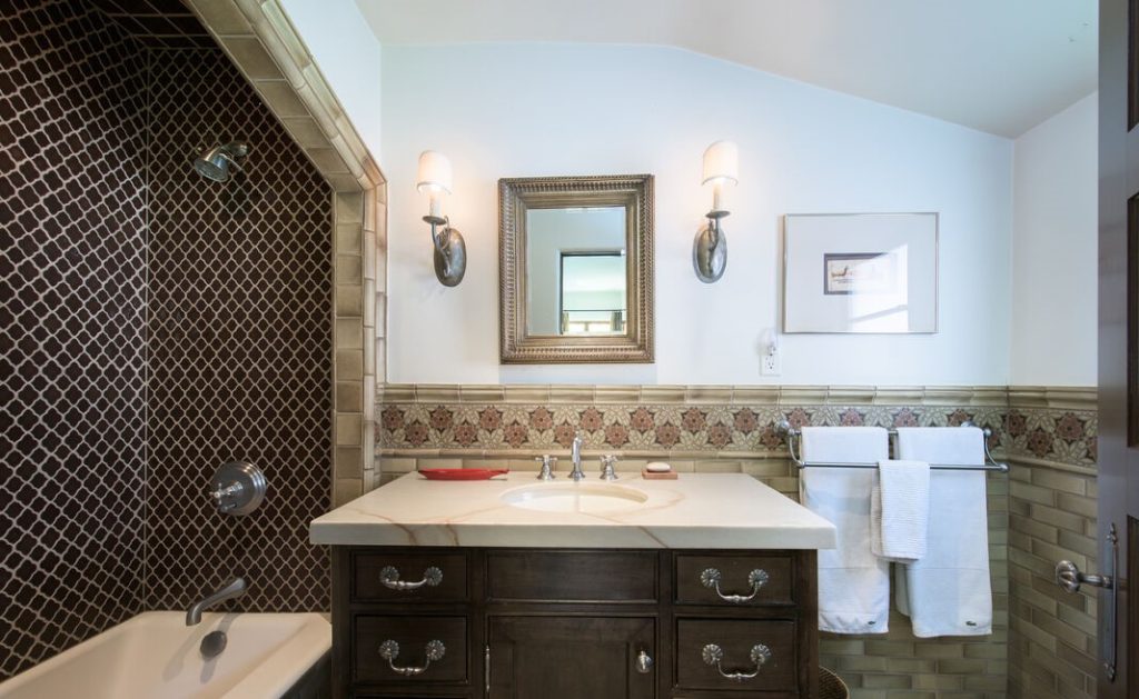 Upstairs is two luxurious suites, each with custom tile baths.