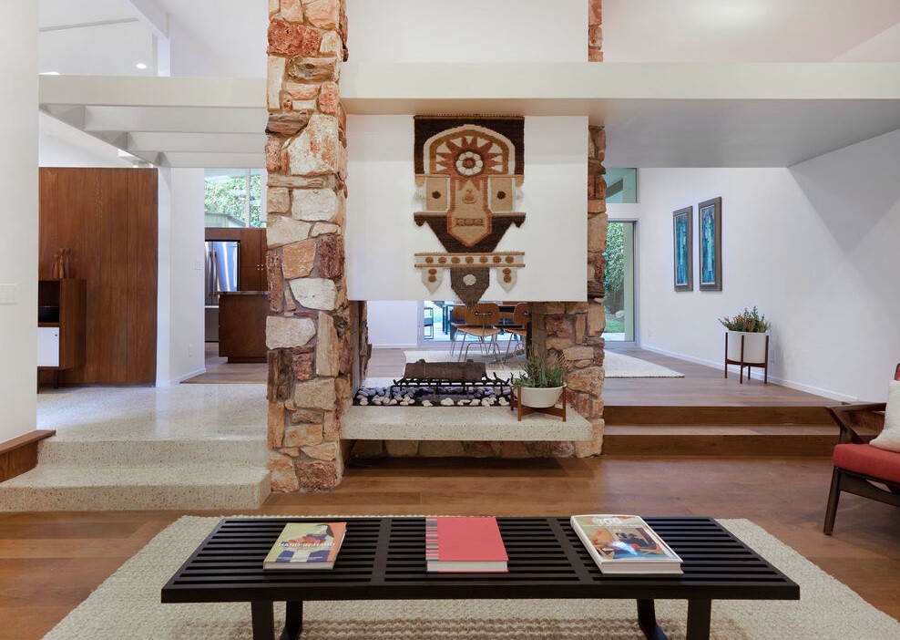 Walk in and marvel over the original terrazzo tile flooring in the foyer, original stone fireplace with terrazzo tile mantles, transitioning to the kitchen