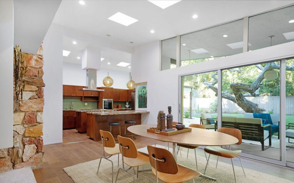 the kitchen featuring marble countertops, imported tile, and top of the line appliances with indoor/outdoor 3D pocket serving window.