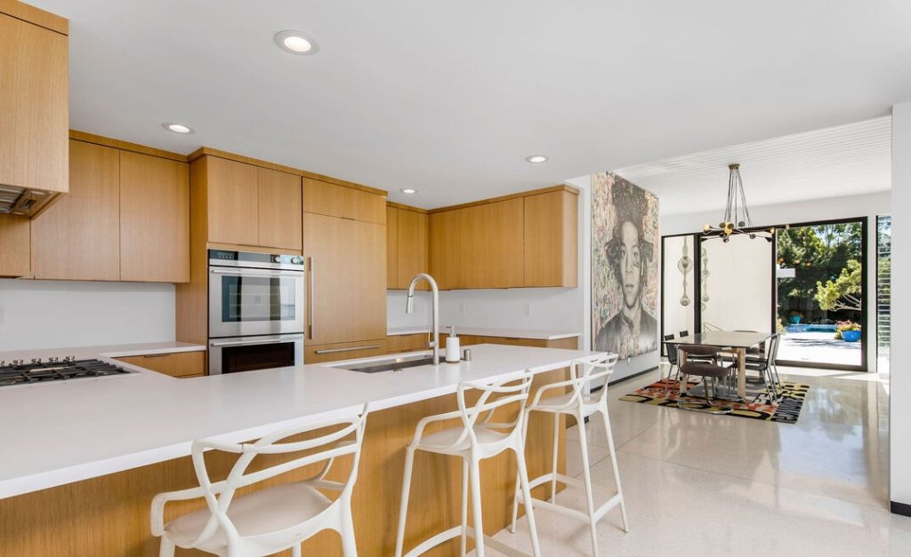 Thoughtfully designed chef's kitchen with designer appliances and exquisite custom cabinetry opens to the dining area and sunken living room.