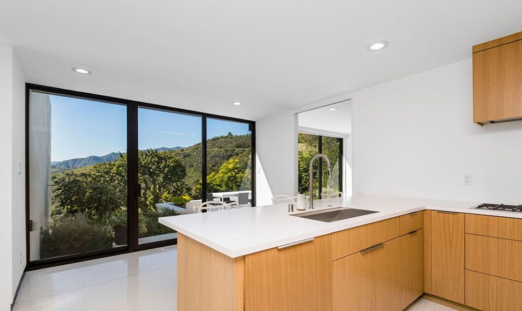Thoughtfully designed chef's kitchen with designer appliances and exquisite custom cabinetry opens to the dining area and sunken living room.