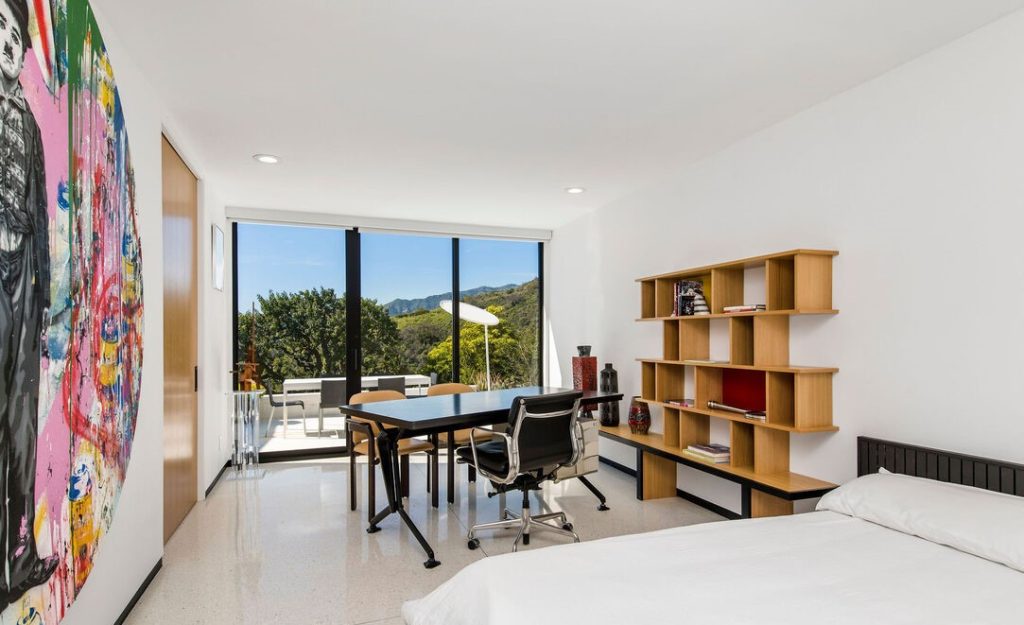 The expansive primary suite with a walk-in closet and private sauna, opens out to the pool deck