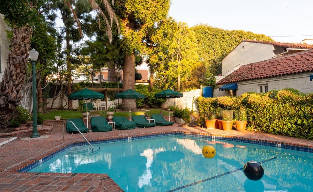 Enjoy resort-style living with a beautiful pool and lush outdoor spaces that evoke a serene oasis, perfect for relaxing and enjoying the Southern California sun.