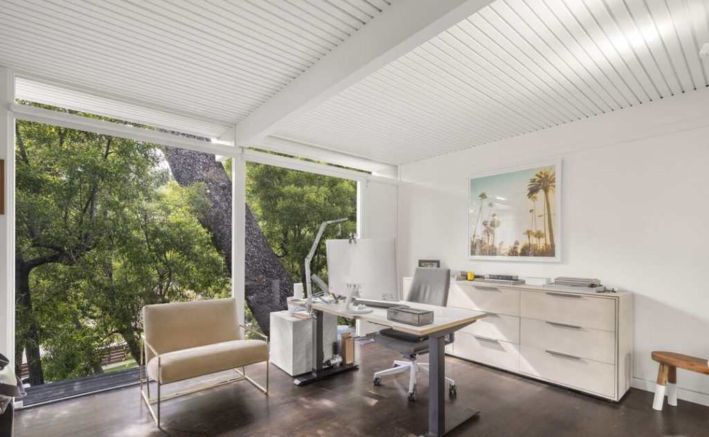 This renovated mid-century features floor to ceiling walls of glass creating a glow of natural light throughout while perfectly framing the views of the city.