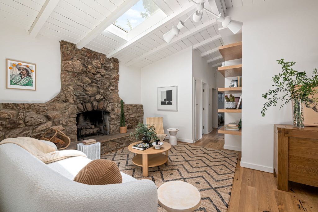 Gorgeous wood floors, an exceptional stone veneer fireplace, some artful original tile and stunning new lighting all create an eclectic and warm vibe.