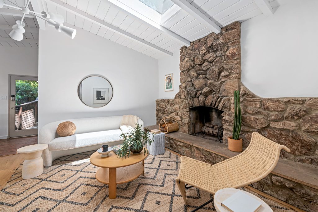 Gorgeous wood floors, an exceptional stone veneer fireplace, some artful original tile and stunning new lighting all create an eclectic and warm vibe.