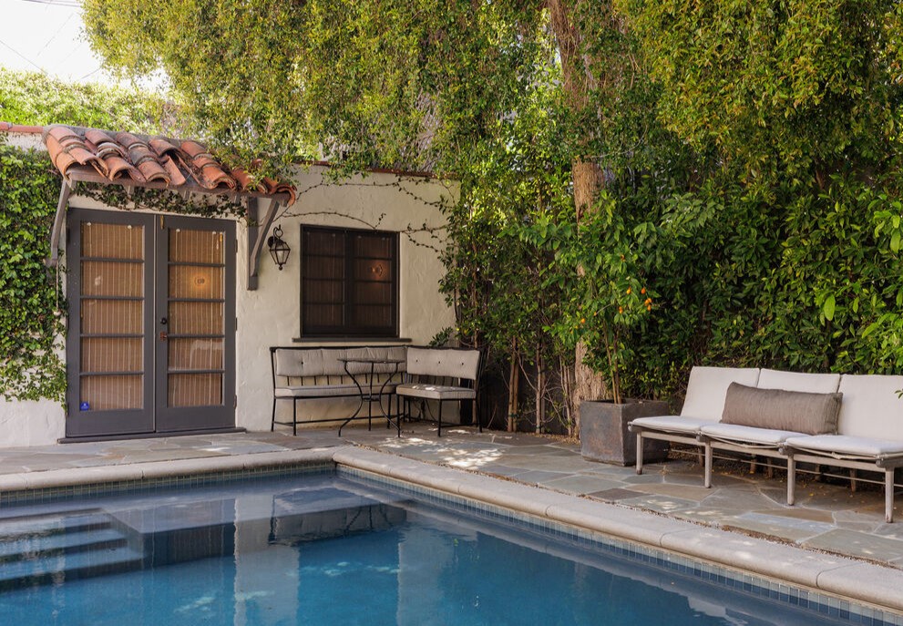 The remarkable outdoor areas include a lush rear yard with a swimming pool and lounging deck.