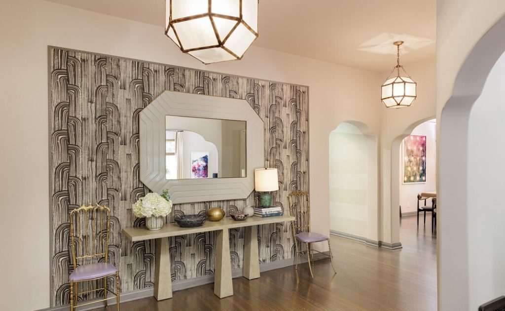 The large foyer with over-sized hexagon globes and striking framed accent wall provides a central opening to all public rooms