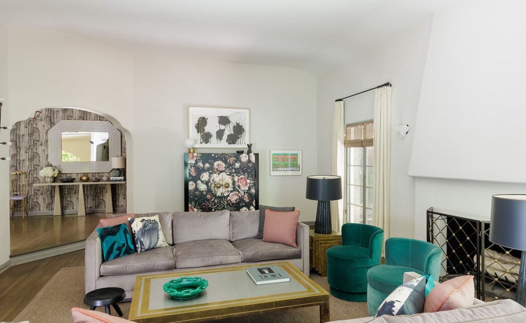 a step-down living room with high ceiling & fireplace, a dramatic formal dining room with coved ceiling & antique mirrored accents, and a cheerful library/study