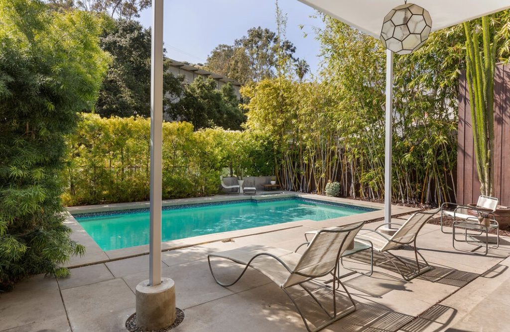 A spacious swimming pool and a separate, tucked-away spa and outdoor shower are set amid complete privacy in a lush setting.