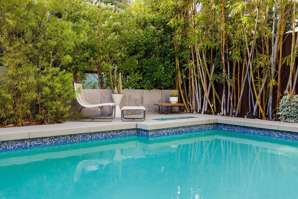 A spacious swimming pool and a separate, tucked-away spa and outdoor shower are set amid complete privacy in a lush setting.
