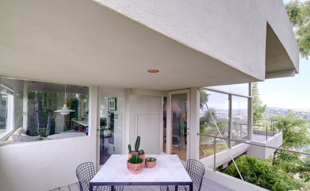 follow the light to the main living area on the level below where living room, dining area, and kitchen flow seamlessly to an outdoor garden patio, or the panoramic City views.