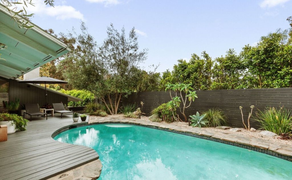 Sparkling pool in this post and beam home in the Hollywood Hills offers up mid-century bones with modern touches.