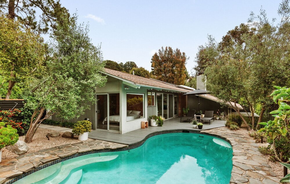 Sparkling pool in this post and beam home in the Hollywood Hills offers up mid-century bones with modern touches.
