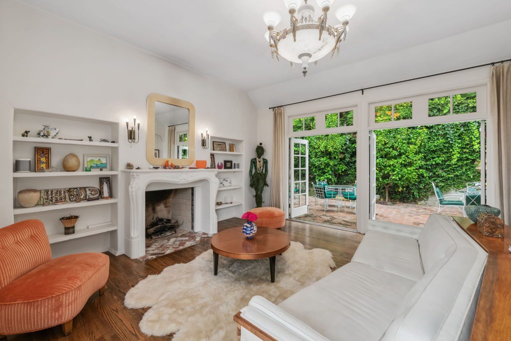 The light filled living room boasts double french doors opening out to quaint European feeling patio and a fountain where hummingbirds come to feed