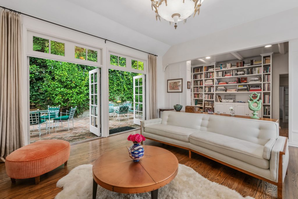 The light filled living room boasts double french doors opening out to quaint European feeling patio and a fountain where hummingbirds come to feed