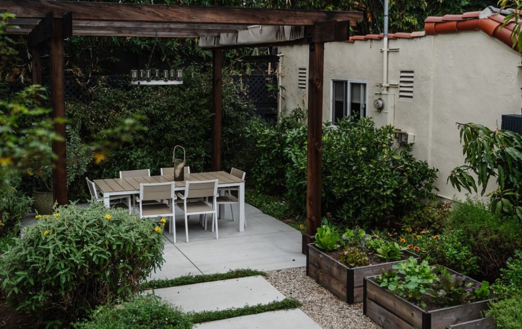 The back garden is lushly planted and the perfect entertaining space.